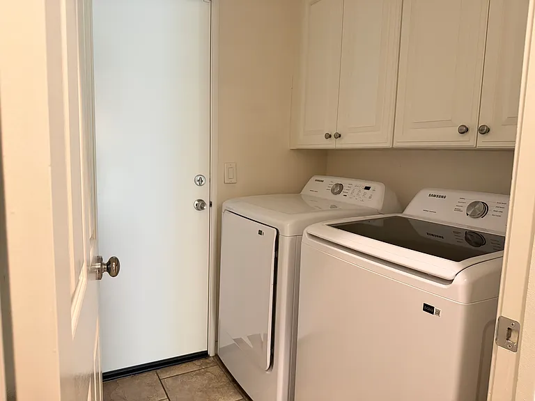 Laundry room with new washer and dryer