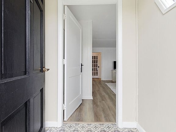 The cozy vestibule adds both character and convenience, offering a comfortable entry before stepping into the main living space.