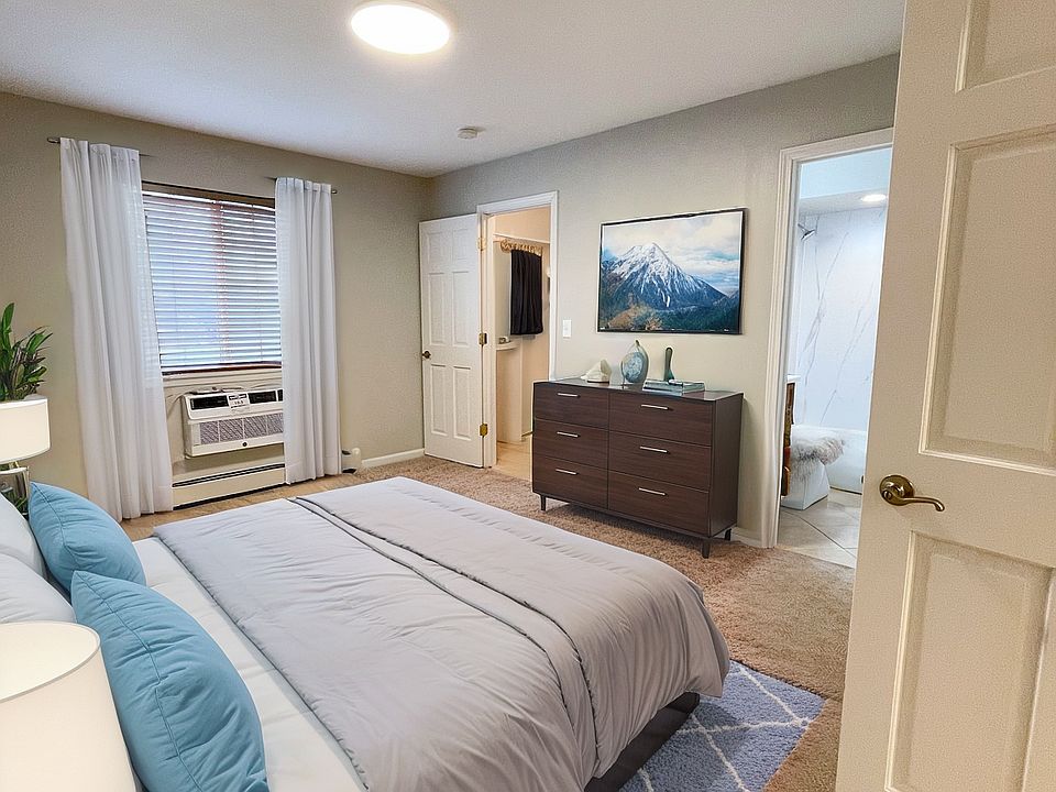 Virtually Staged Primary Bedroom with Separate Bathroom and Walk-In Closet