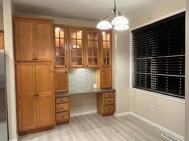 Pantry, Desk and Lighted Galss Cabinets with rain shower glass