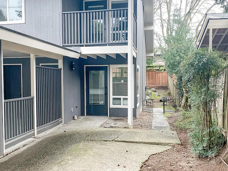 private front yard with door into dining area and covered deck from 2nd bedroom
