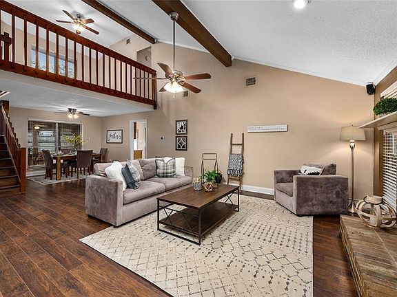 Notice the recent flooring throughout the home. Open floor plan, dining room behind the living room, kitchen to the right, and gameroom area upstairs. Vaulted ceiling opens the space up.