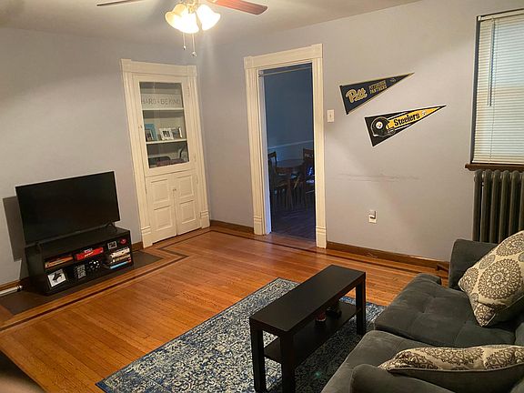 Living room with hardwood floors throughout the apartment