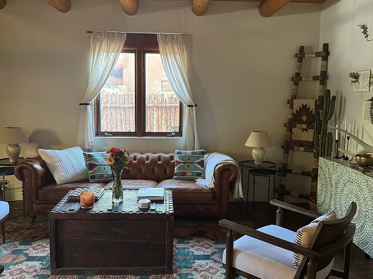 Thoughtfully designed living space with curated furnishings and working Kiva fireplace