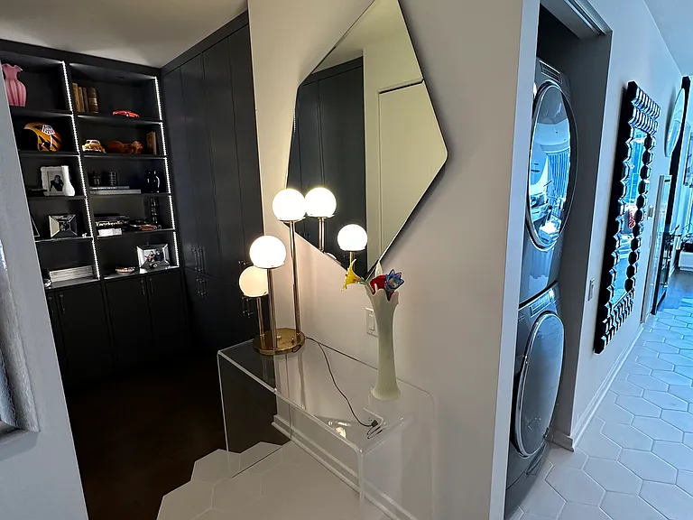 Den with custom high end storage, and custom built in entry closet
