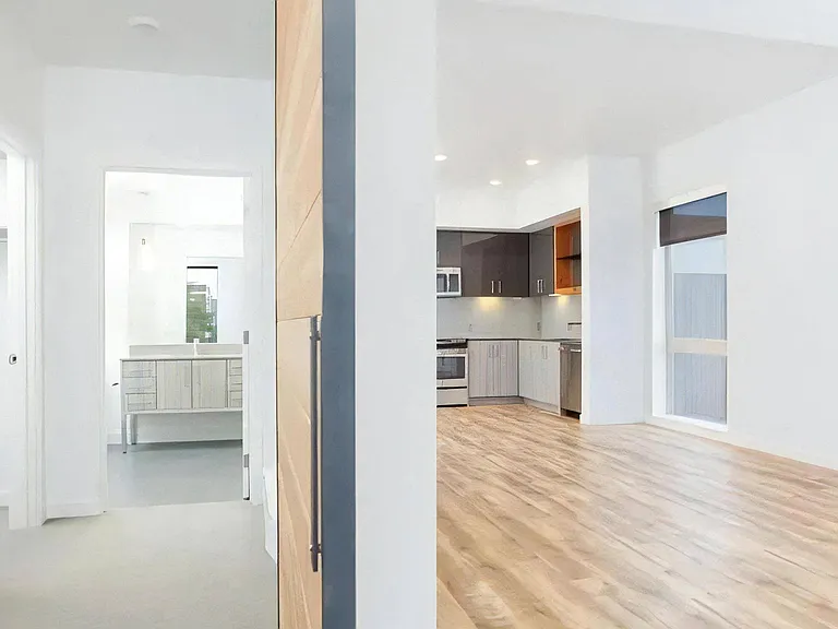 Apartment Entryway Showing Hall to Kitchen and Bathroom Vanity