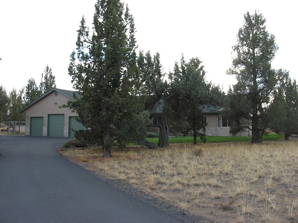 Gently Winding asphalt driveway into 5 acre homesite