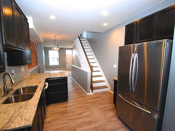 Modern kitchen with new counter tops, sink, cabinets, and ap