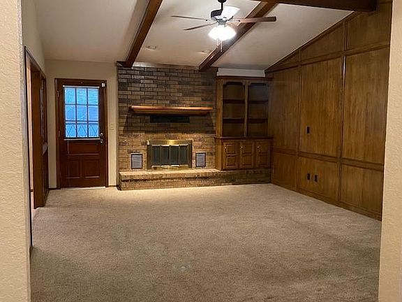 Large spacious living room with faux fireplace