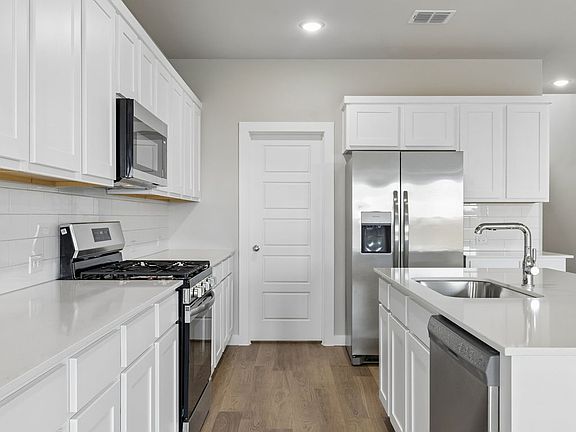 Kitchen in the Winters home plan by Trophy Signature Homes - REPRESENTATIVE PHOTO