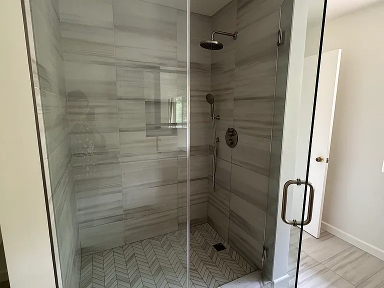The new master bathroom shower has rain head and separate hand held options.