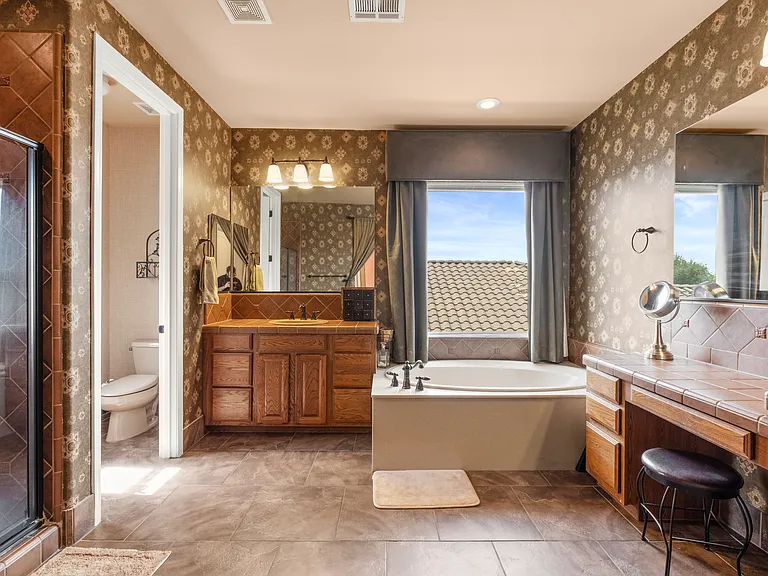 Master bath with a tub, separate shower and 2 separate sink areas.