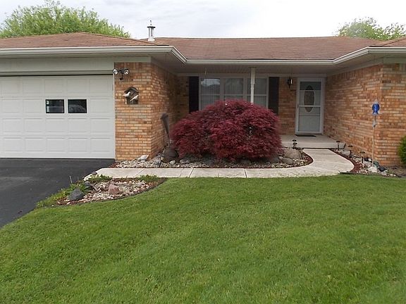 Closer view of front exterior of home. Two car attached garage offers keyless entry