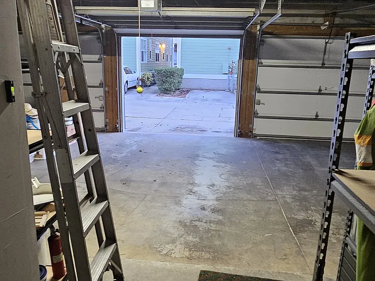 The garage is 'shared' with the neighbors on each side of the unit. The middle space shown here is designated for the unit but there are just no walls in between the other unit's spaces. There are storage shelves in the garage that are available for use.
