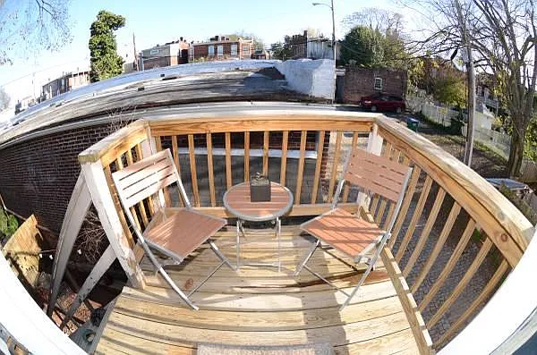 Small deck that leads to charming courtyard with tiki bar