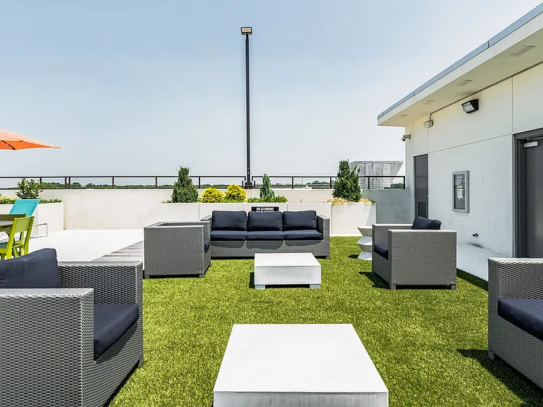 Green Space with Cornhole Boards and Seating on Rooftop Deck