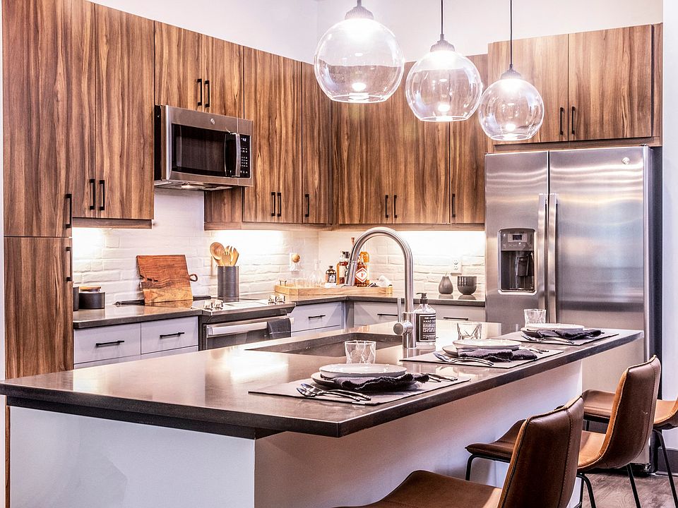 Our chef-inspired kitchens feature stainless steel appliances and side-by-side refrigerators.