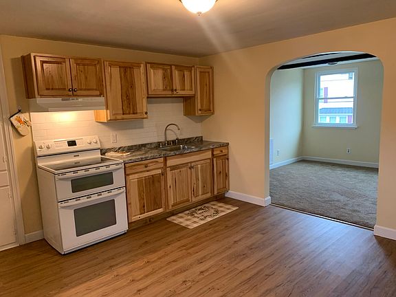 Brand new kitchen flooring, cabinets, and sink. Double oven with electric stove top.