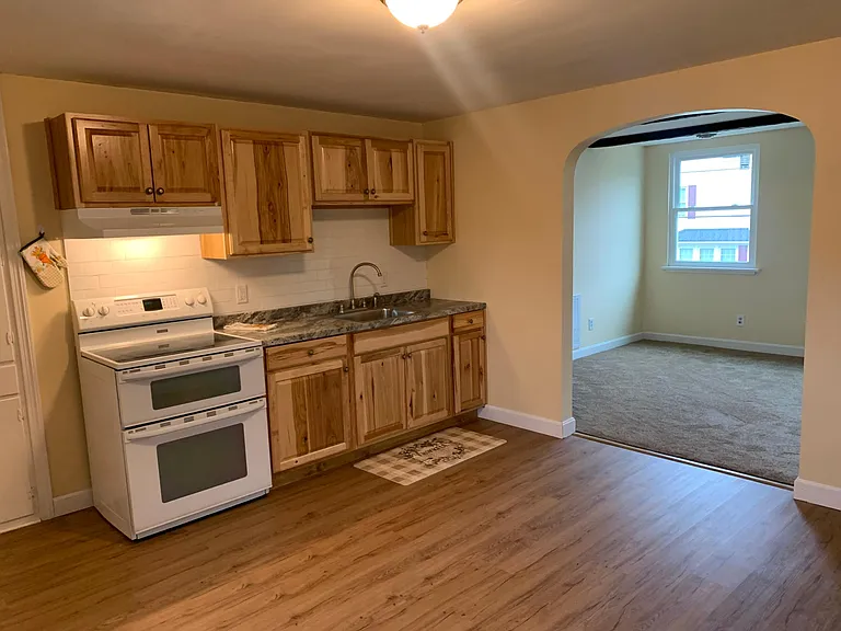 Brand new kitchen flooring, cabinets, and sink. Double oven with electric stove top.
