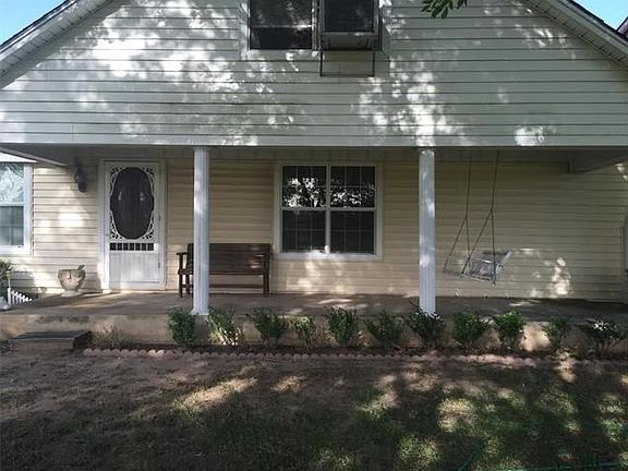 The front porch swing says come and sit and enjoy.