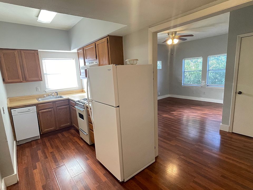 Cozy kitchen with Euro-style electric range, dishwasher and fridge.