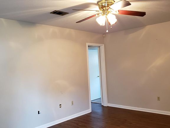 large living room with a ceiling fan