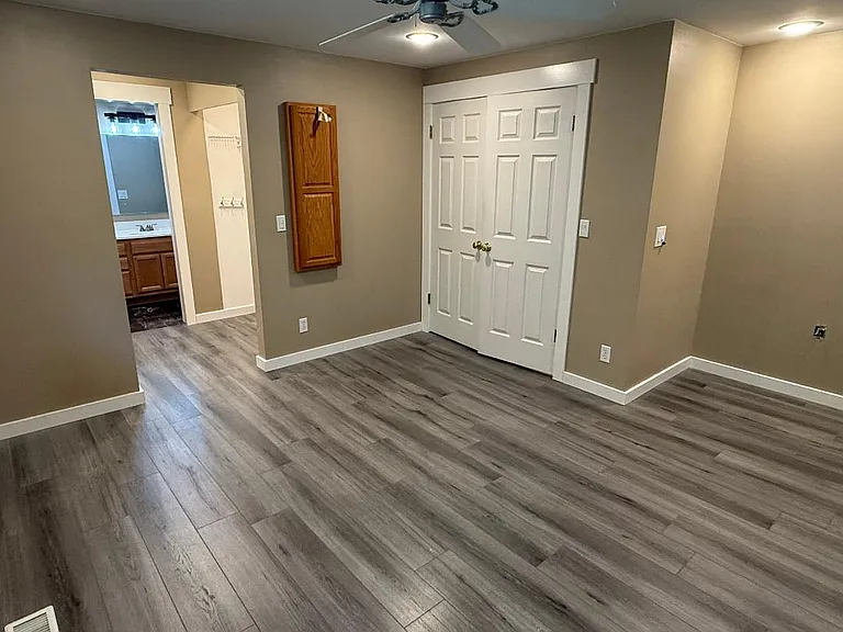 Bedroom #3 on upper level. Large, spacious master bedroom. Has remote controlled ceiling fan and dedicated ironing cabinet. Leads to pass through clothes closet (6' of hanging space on the left and right). Leads to master bath.