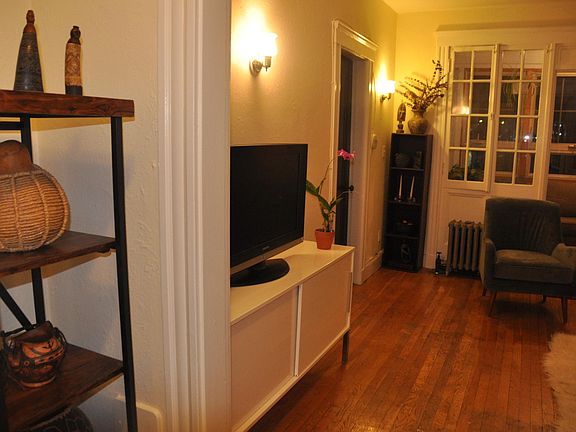 Living room/dining area, closed-in porch, and entryway.