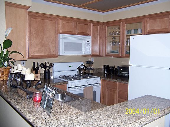Gorgeous kitchen with granite counter tops and upgraded glass cabinets.