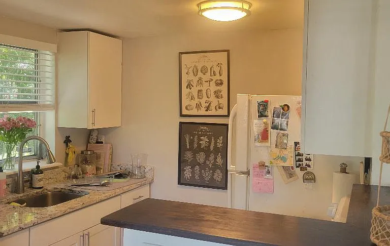 View of kitchen from dining area showing breakfast counter and window over sink!