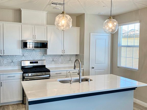 Upgraded modern pendant lighting over kitchen counter