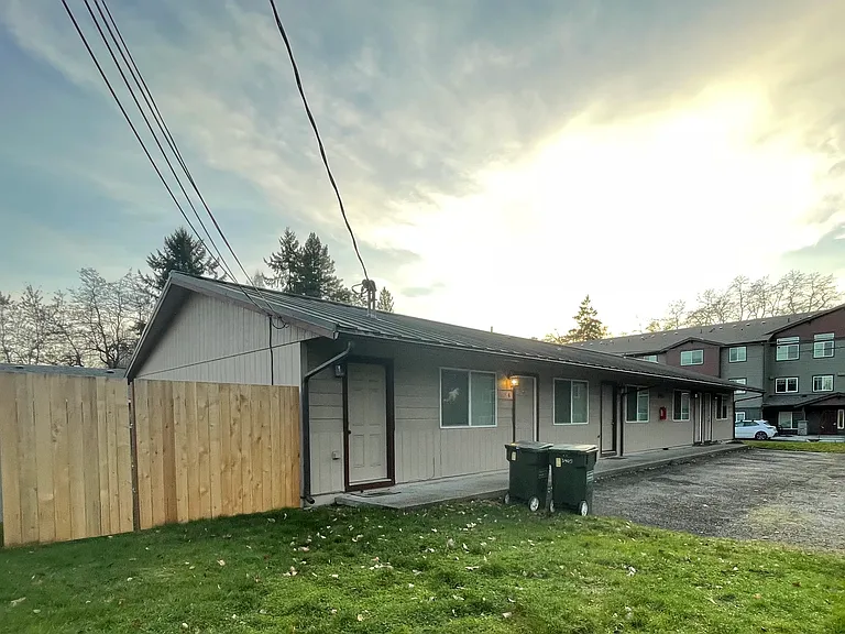 Fully fenced. Locked laundry and storage is on this end of the building. Each renter has a parking space immediately in front of their door.