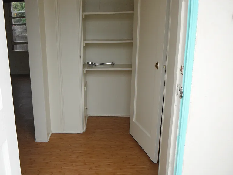 Looking in front door into linen closet. Kitchen is to right, Living Room to left.