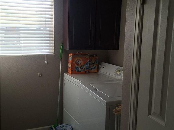 Laundry room with cabinets.  Great garage access, tile floors and new water heat