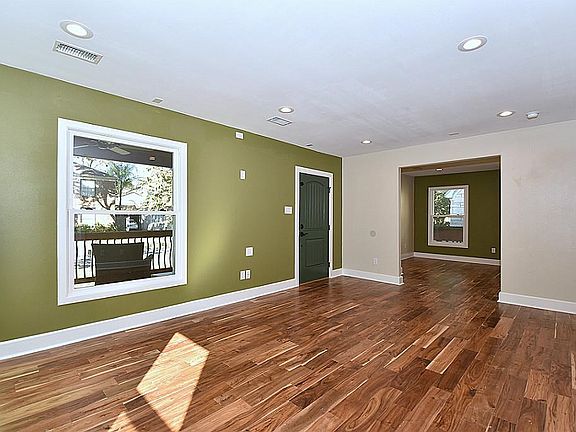 Standing in the Living Room, looking at the front door as you walk in from the porch.  The floors are half inch thick tobacco Acaia hand scraped hardwood. The windows are new Pella 350 Series.  All new sheetrock throughout.