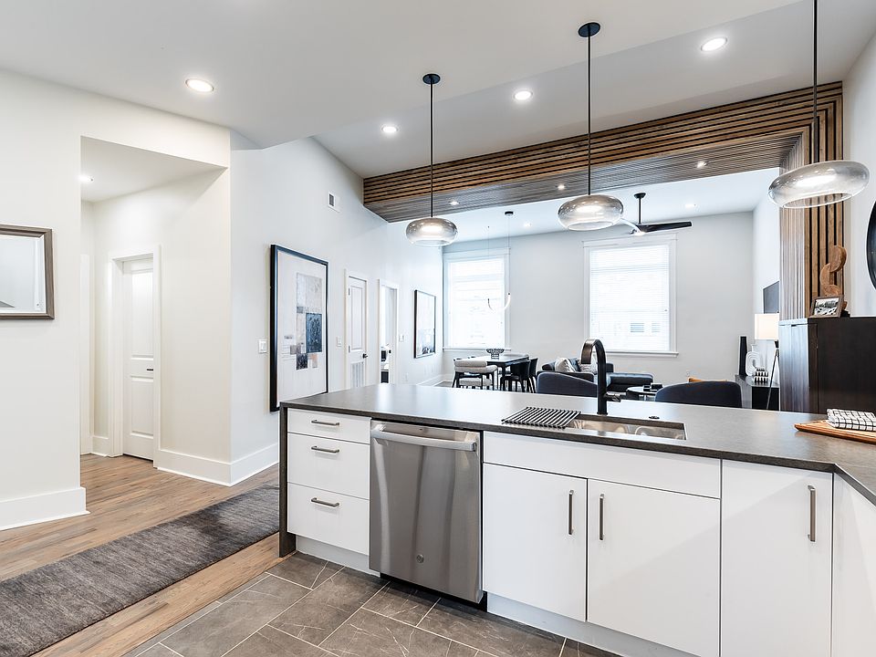 Kitchen opens to great room and has cool lighting and fixtures.