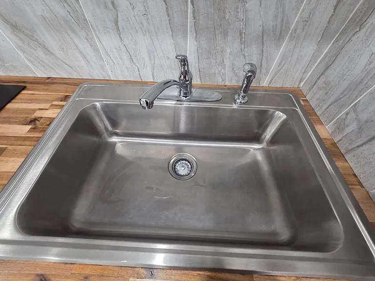 Clean and practical sink area with essential amenities included.