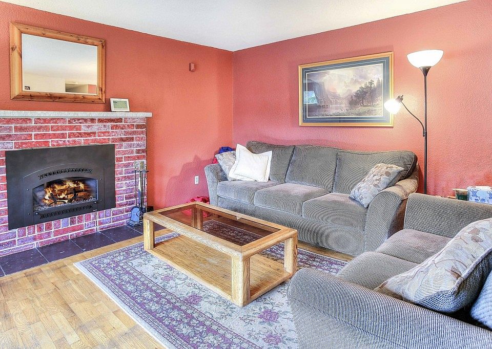 This living room has a newer gas fireplace and hardwood floors.