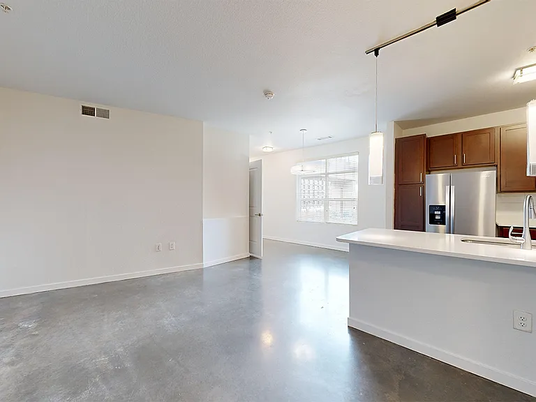 Apartment living room with polished-concrete flooring.