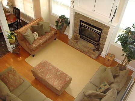 Two story family room w/ hardwood floors, TV niche, gas fireplace.