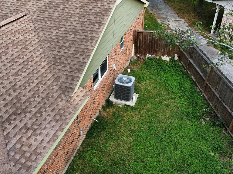 Side of house. Windows shown are for middle bedroom and front bathroom.