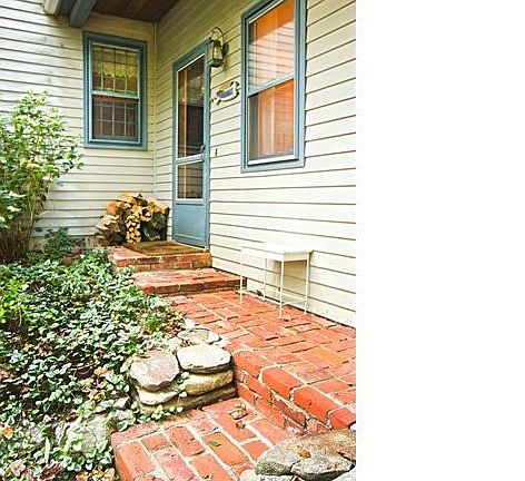 The porch leads to a second front entranceway.