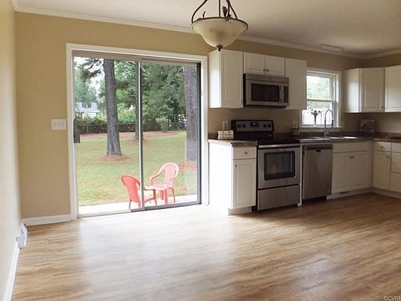 eating area of the kitchen with sliding glass door to the patio and rear yard.
