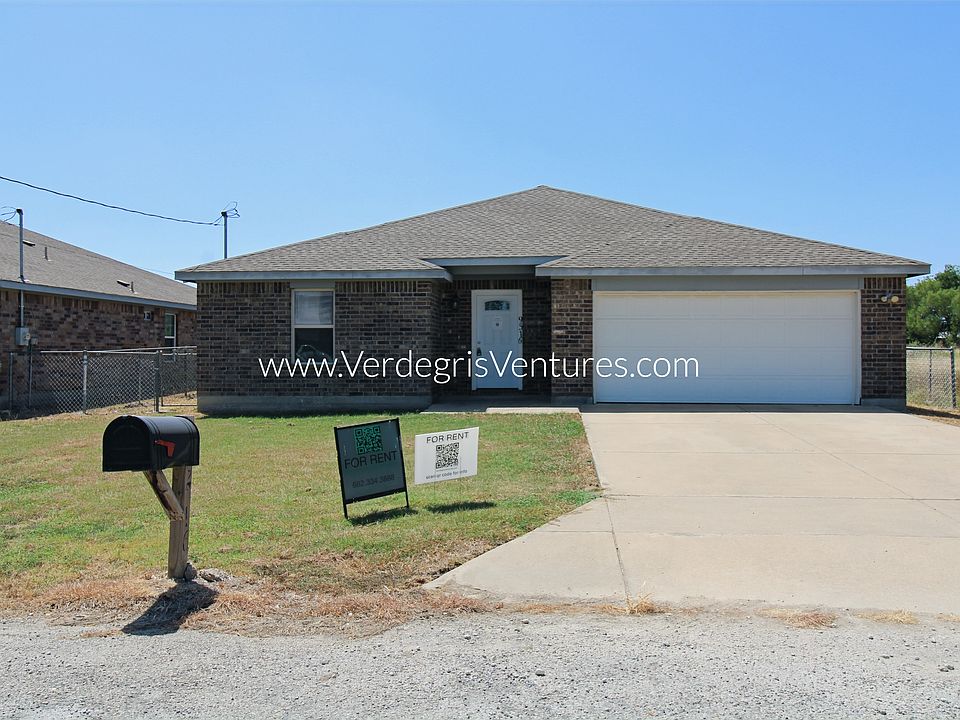 Located on a quiet, low_traffic street with no neighbors behind, offering peaceful prairie views, a two_car driveway, and a covered front porch