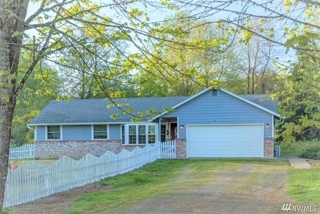 Front of home with extra long driveway and attached 2 car garage.