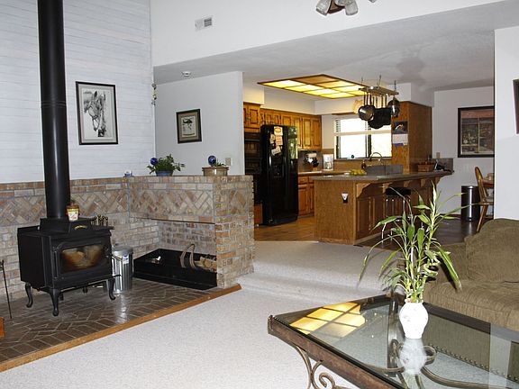 View from front door includes updated kitchen, wood stove and dining bar.