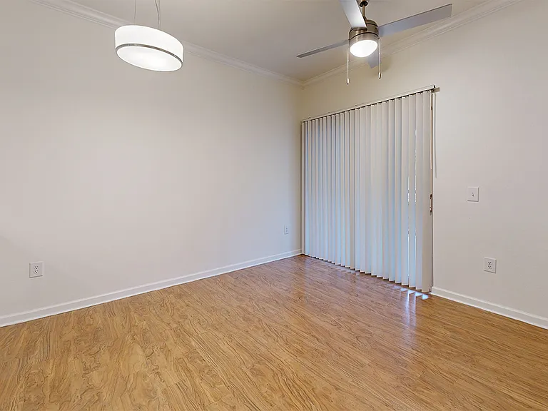 Apartment dining and living room with wood-style flooring.