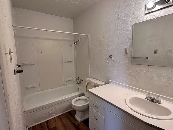 Bathroom with a shower/tub combo and plenty of counter space for everyday use.