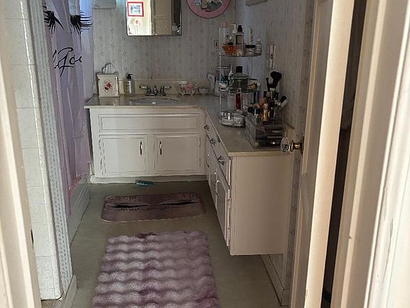 Shared bathroom with full bath and shower , single sink.