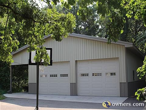 Wood framed, heated shop, 2 disservice doors, 2 garage doors